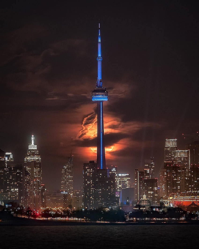 The CN tower in front of an ominous Super Blood Moon. One HD phone wallpaper