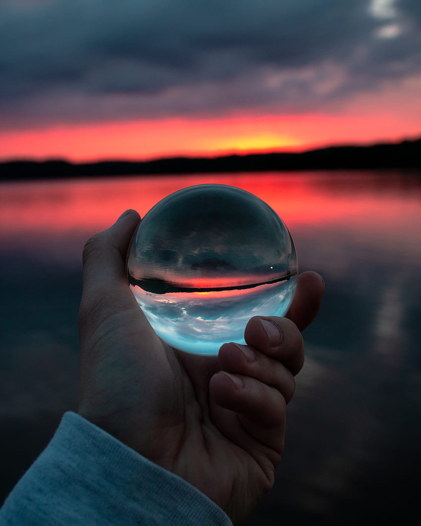 Person Holding Clear Glass Ball · Stock HD phone wallpaper