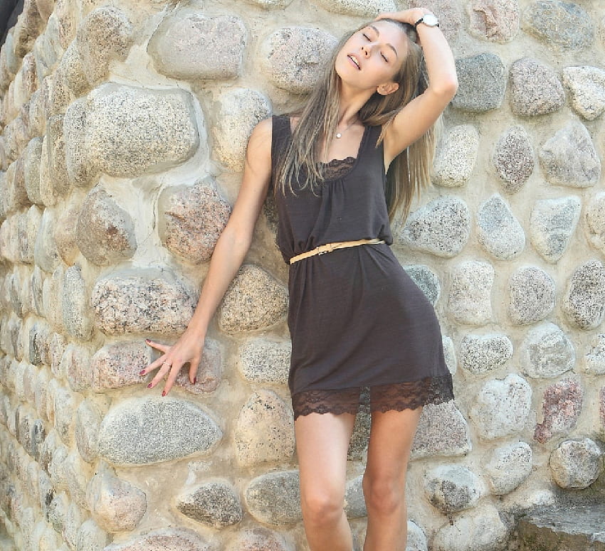 Anjelica Ebbi, pendant, blonde, wrist watch, posing, jewelry, black dress, stone wall, thin belt, lace trim HD wallpaper