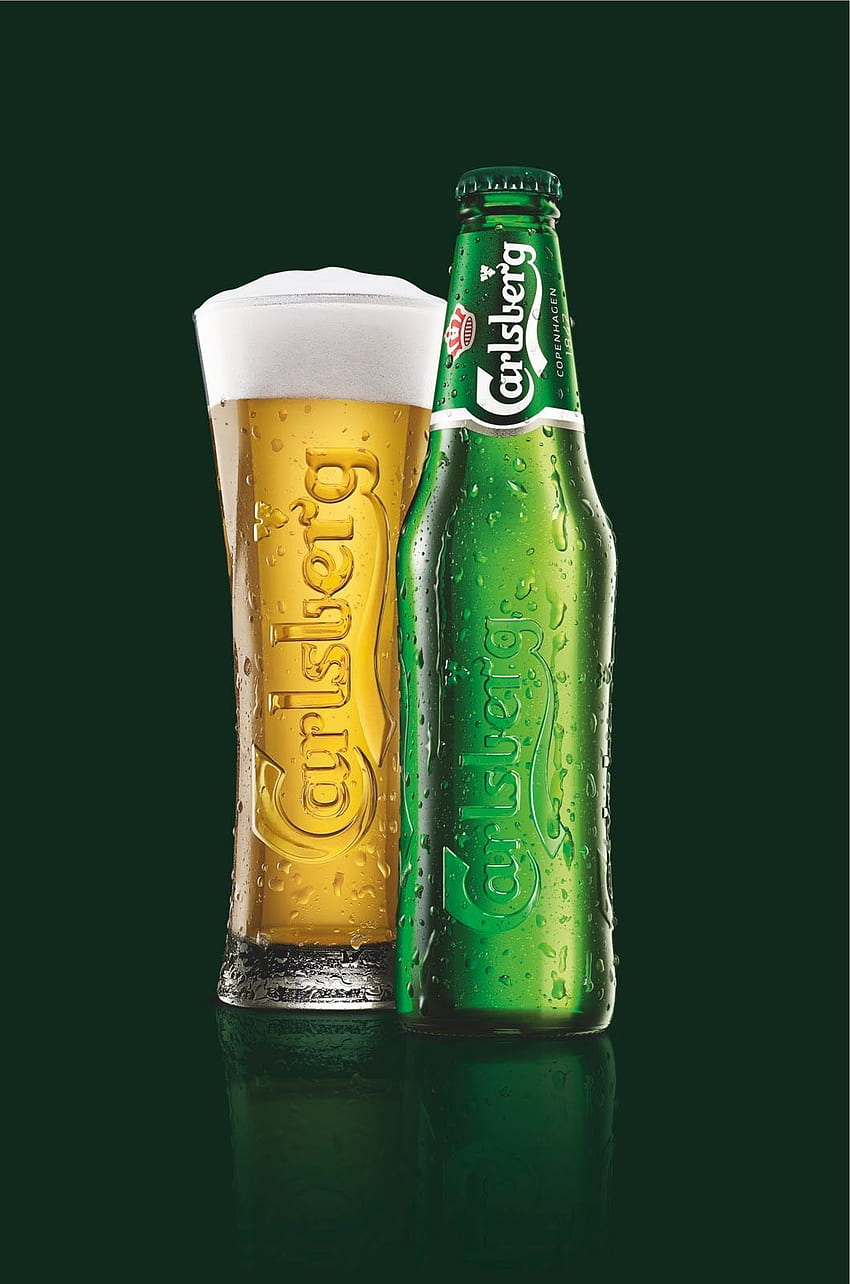 MINSK, BELARUS - AUGUST 23, 2016: Tuborg Glass Bottle Beer On Green  Background. Tuborg Northern Suburb Of Copenhagen, Denmark. It Has Been Part  Of Carlsberg Group Since 1970 Stock Photo, Picture and
