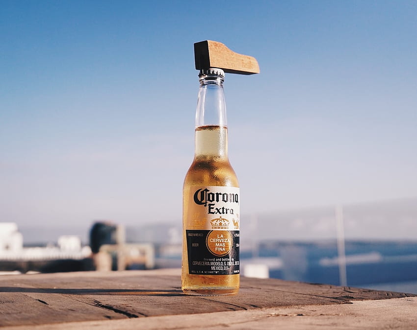 corona extra beer bottle on brown wooden table – on Unsplash HD wallpaper
