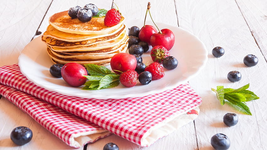 Pancakes on a white plate with blueberries, cherries and strawberries HD wallpaper