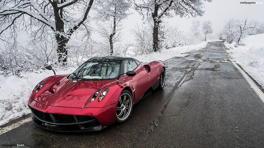 Red Pagani Huayra on winter road HD wallpaper