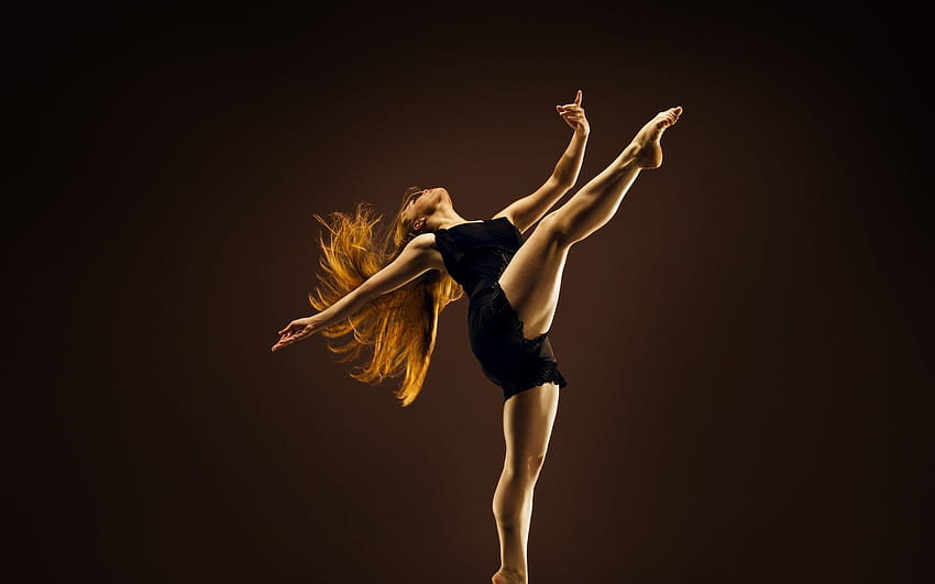 Tańcząca kobieta w czarnym kombinezonie bez rękawów. Tapeta HD
