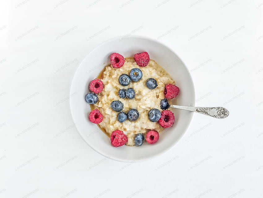 Oat porridge with fresh raspberry, blueberry and honey in a whit by sonyakamoz on Envato Elements HD wallpaper