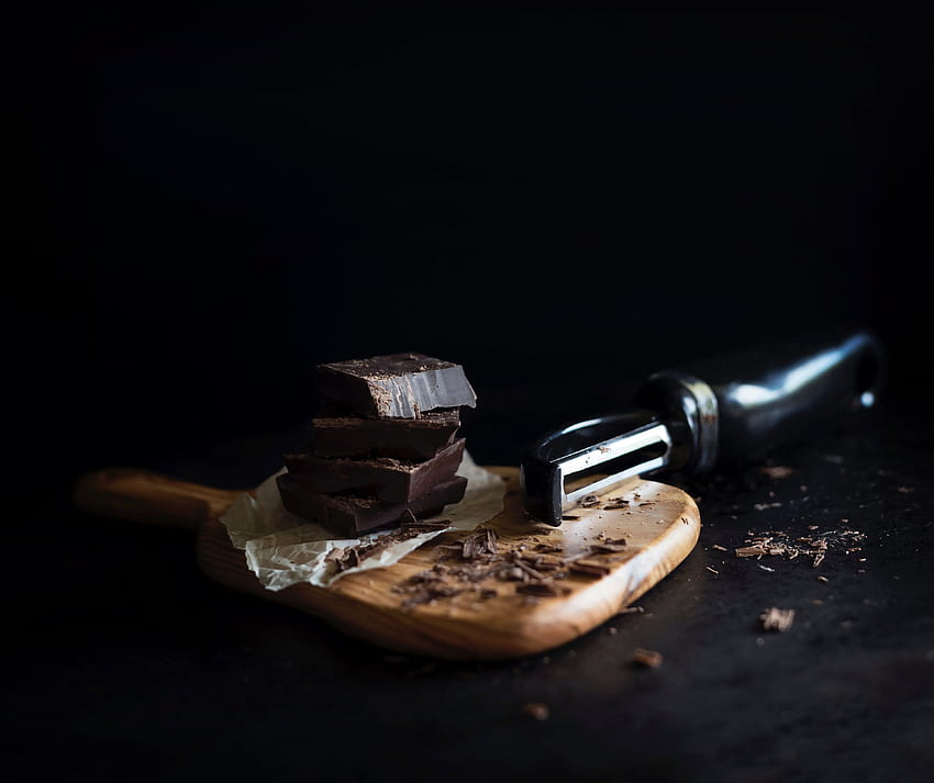 food peeler shreds blocks of dark chocolate on a cutting HD wallpaper