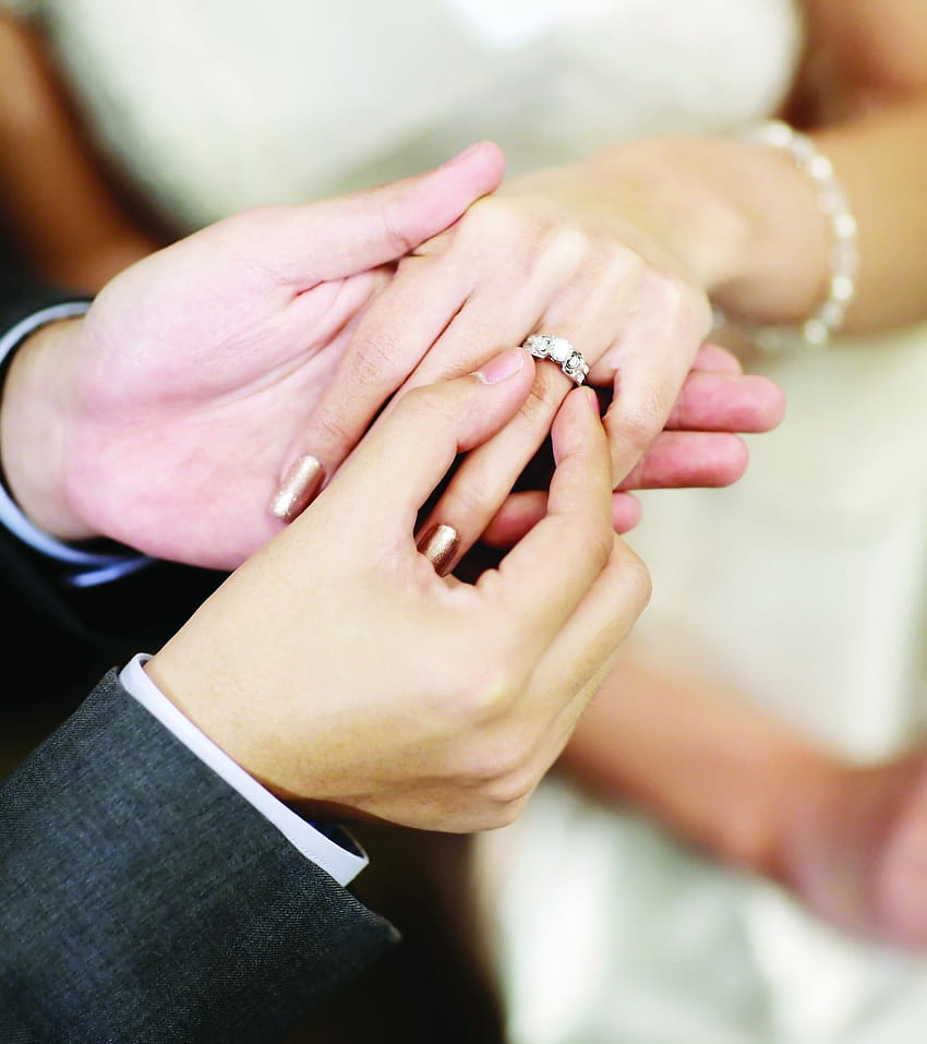 two lovers, a couple, a boy and a girl are holding hands. The girl on her  hand is a wedding ring. the concept of love 9364532 Stock Photo at Vecteezy