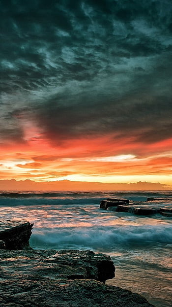 Nice wallpaper with dramatic sky and a small rock in the see on Craiyon