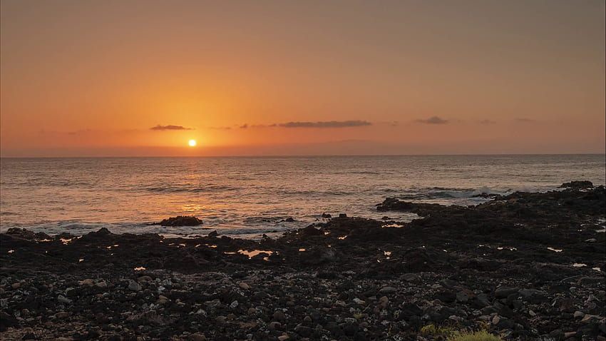 Time lapse of sunset over the Atlantic ocean and the rocky coast of Tenerife, Canary Islands, Spain Stock Video Footage HD wallpaper