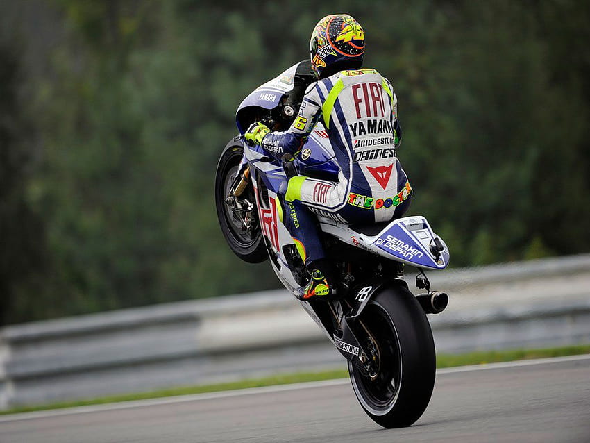 Download Valentino Rossi Perfecting a Signature Wheelie Stunt Wallpaper