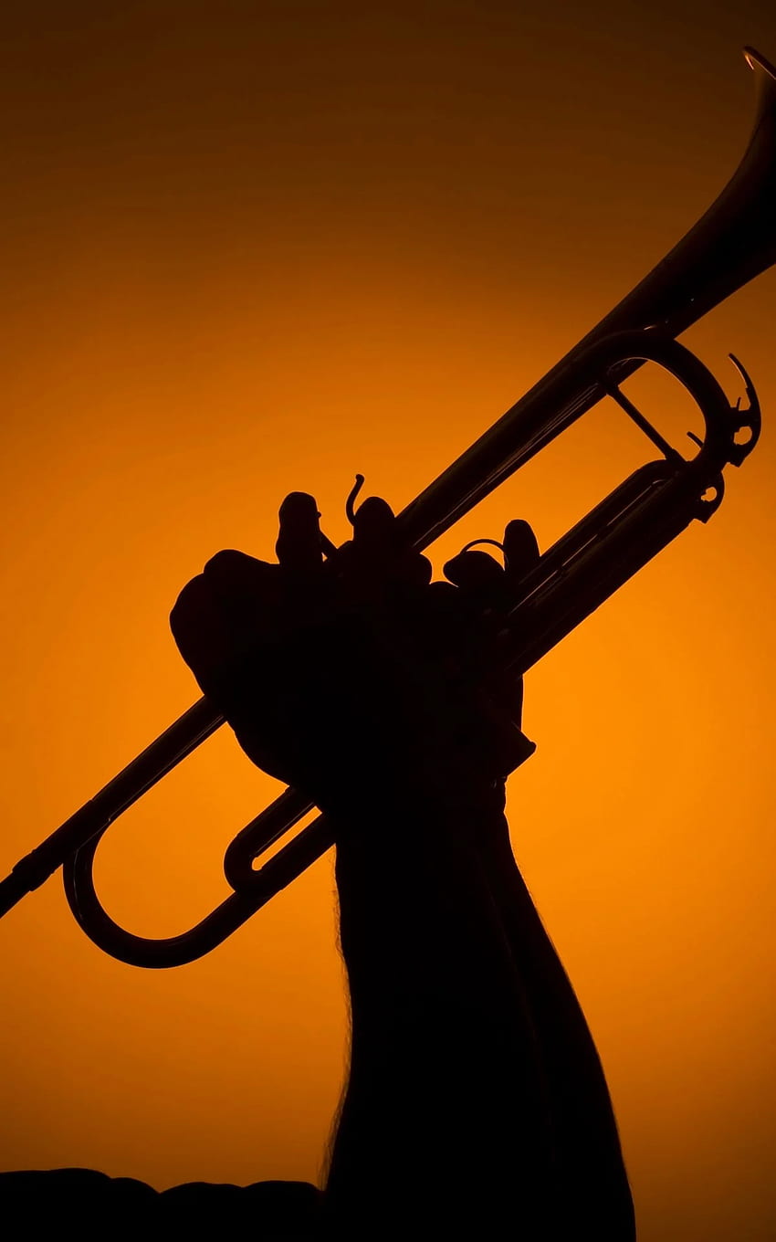 backlight musician playing trumpet on orange HD phone wallpaper