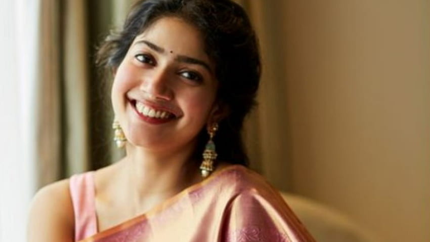 Beautiful Smiling Actress Sai Pallavi Is Wearing Light Pink Saree Sitting In Blur Background Girls HD wallpaper