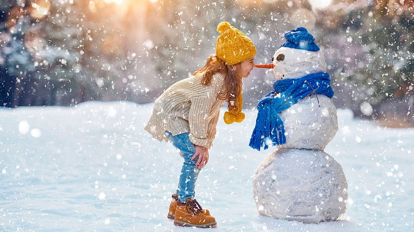 Cute Little Girl Is Standing With Snowman Toy In Snowfall Background Wearing Woolen Knitted Top Blue Jeans And Cap Cute HD wallpaper