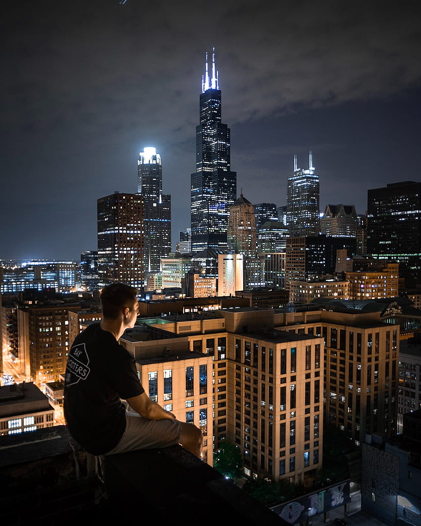 Man Sitting On Rooftop At Night · Stock HD phone wallpaper