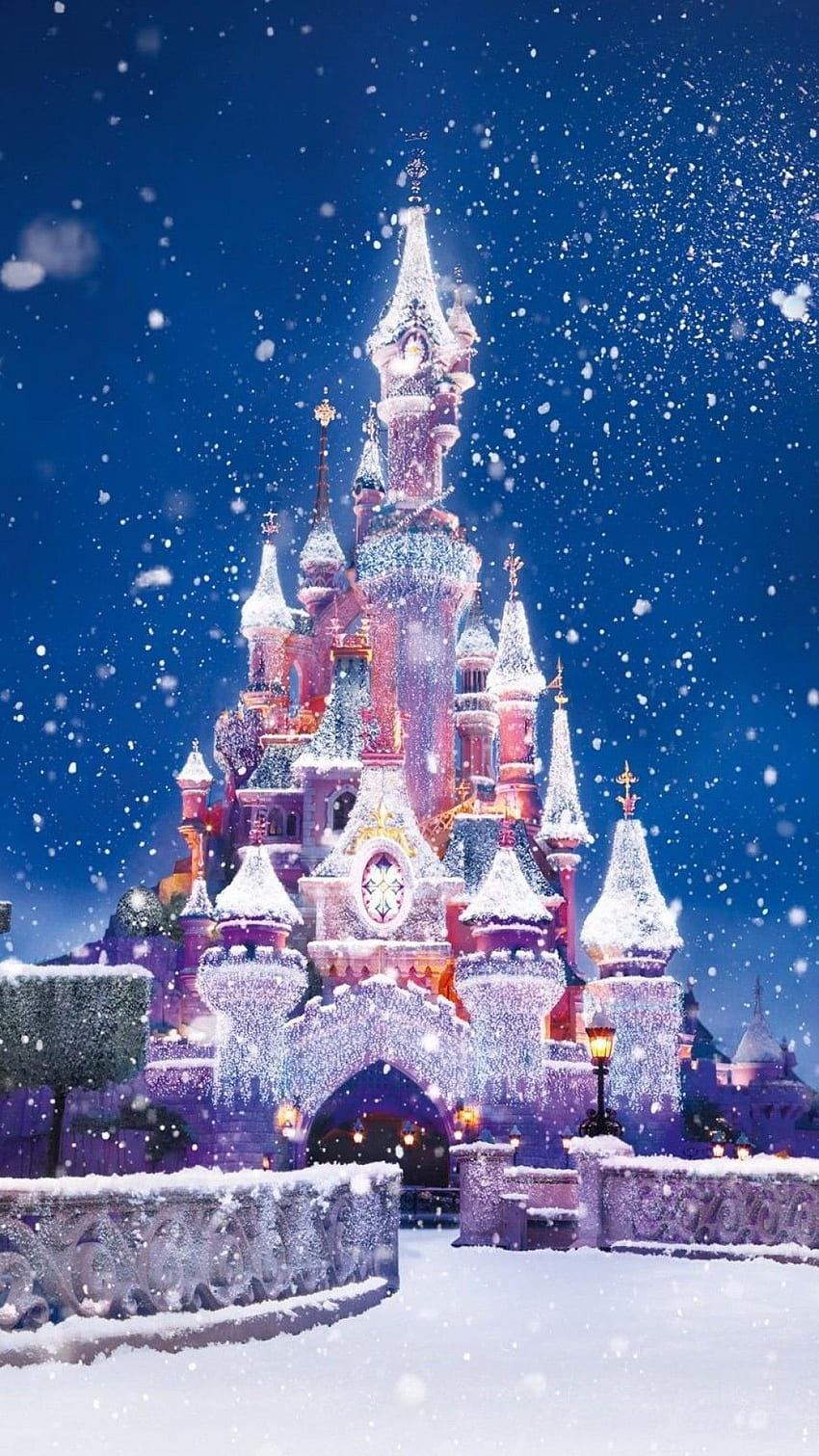 Teléfono de nieve con luces navideñas del castillo de Disney. lindo fondo de pantalla del teléfono