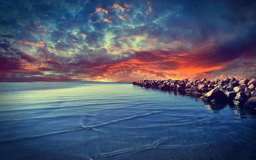 Download A golden sunset over a serene beach Wallpaper  Wallpaperscom