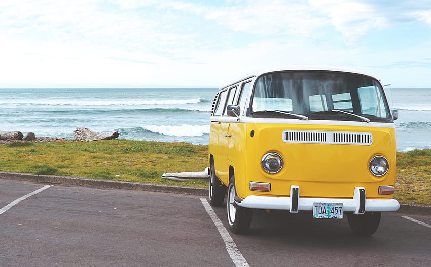 a white and yellow volkswagen bus in a parking lot by HD wallpaper