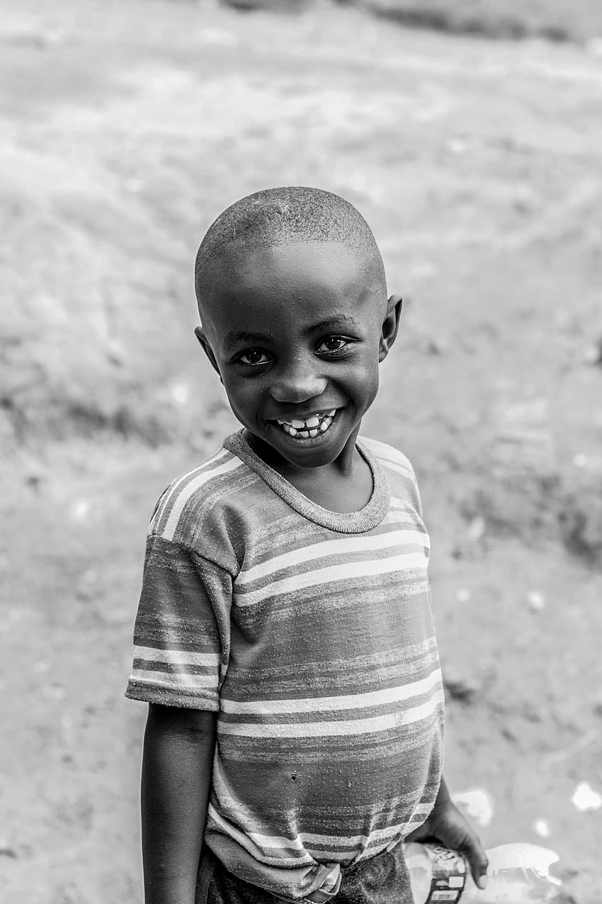 Cheerful African boy in village · Stock HD phone wallpaper