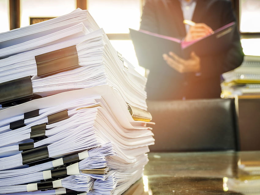 Close up of business documents stack on businessman background - Monash Partners HD wallpaper
