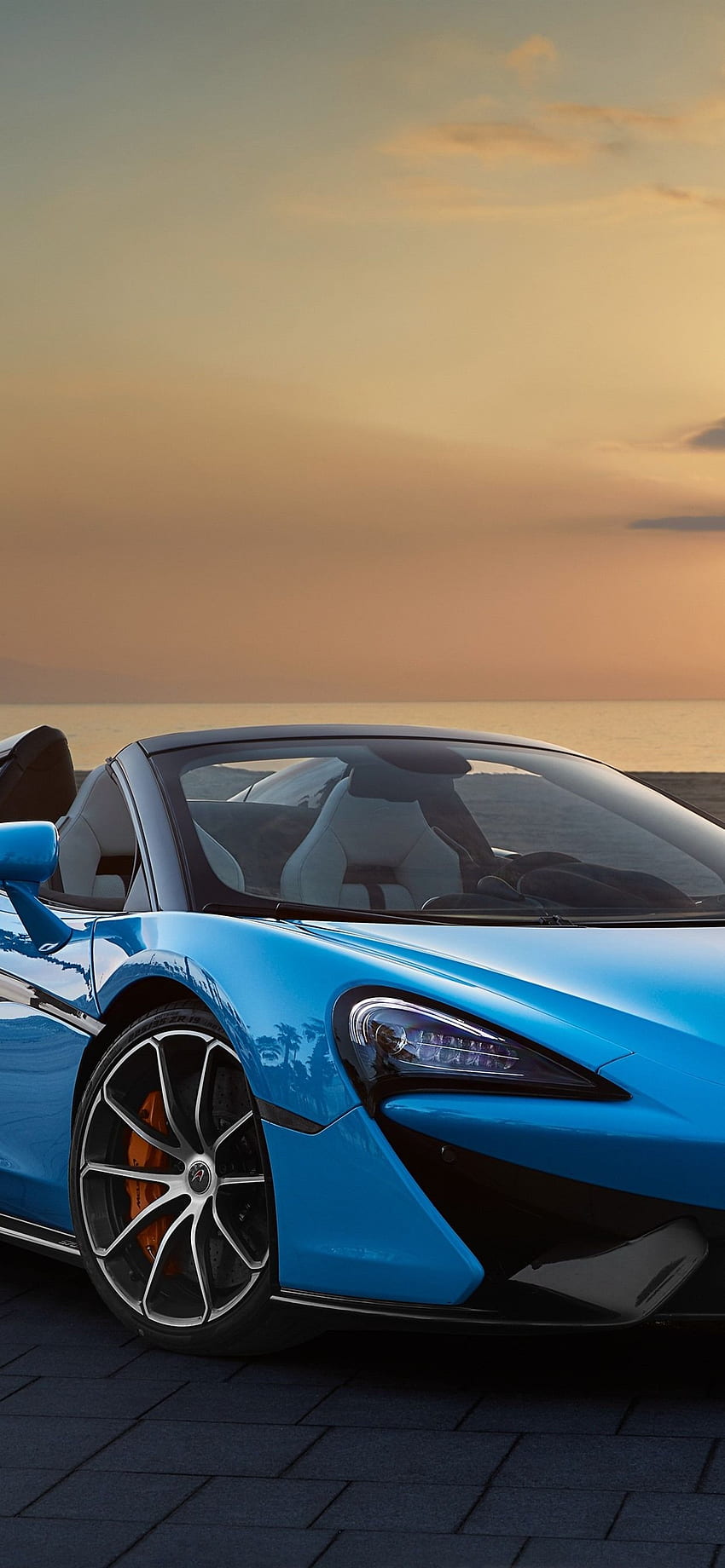 McLaren 570S descapotable azul, atardecer, mar iPhone fondo de pantalla del teléfono