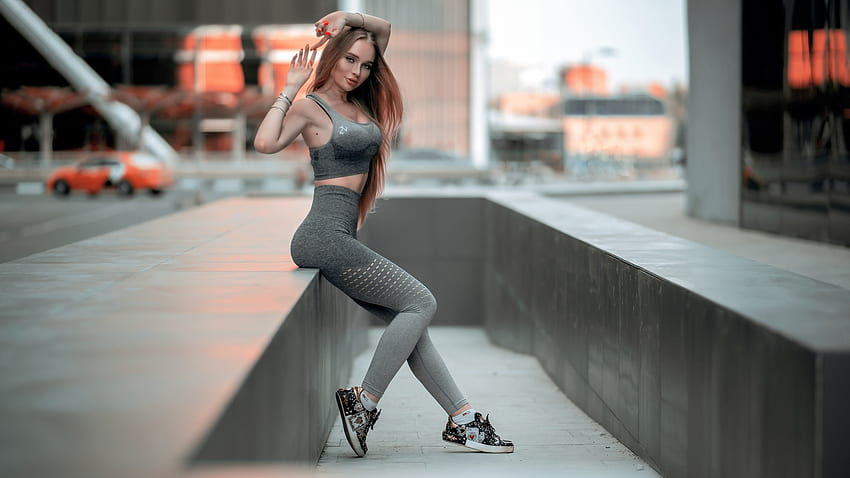 Premium AI Image | A woman in a sports bra top and leggings jumping in the  air generative ai image