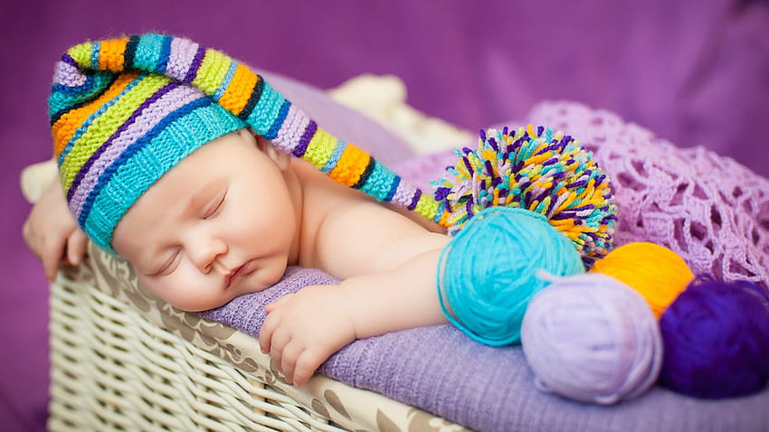 Cute Baby Toddler Is Sleeping Inside Bamboo Basket Wearing Colorful Woolen Knitted Cap In Purple Background Cute HD wallpaper