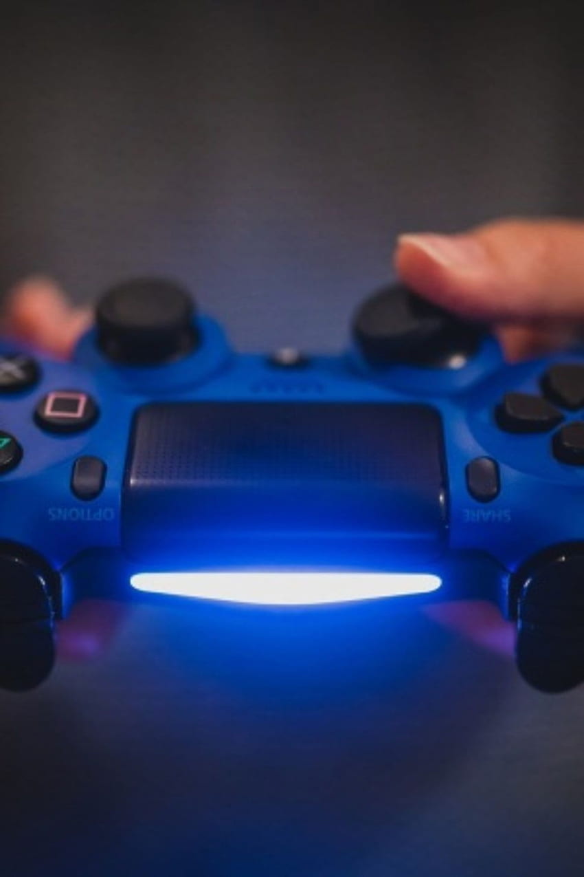 Person holding blue Sony PS4 controller HD phone wallpaper