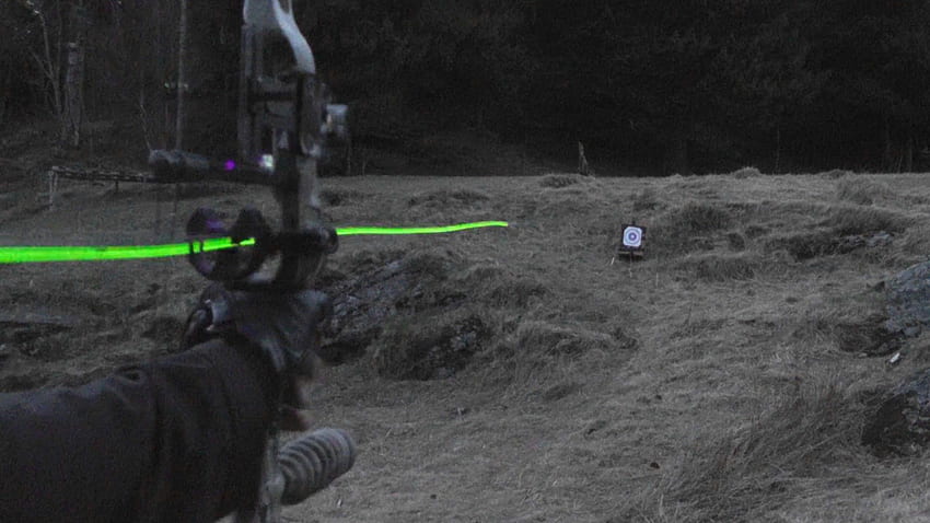 Shooting carbon arrows with lighted nocks from a compound bow HD wallpaper