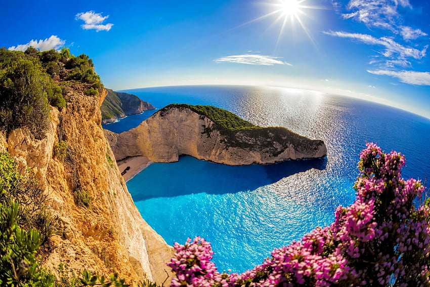 Navagio bay, rays, sunlight, glow, bay, Zakynthos, wildflowers, reflection, Navagio, sun, sunshine, sea, Greece, beautiful, rocks, summer, view, sky HD wallpaper