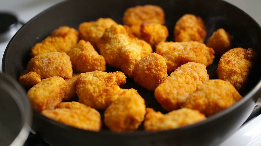 Wooden Shovel Stirs Chicken Nuggets In A Frying Pan HD wallpaper