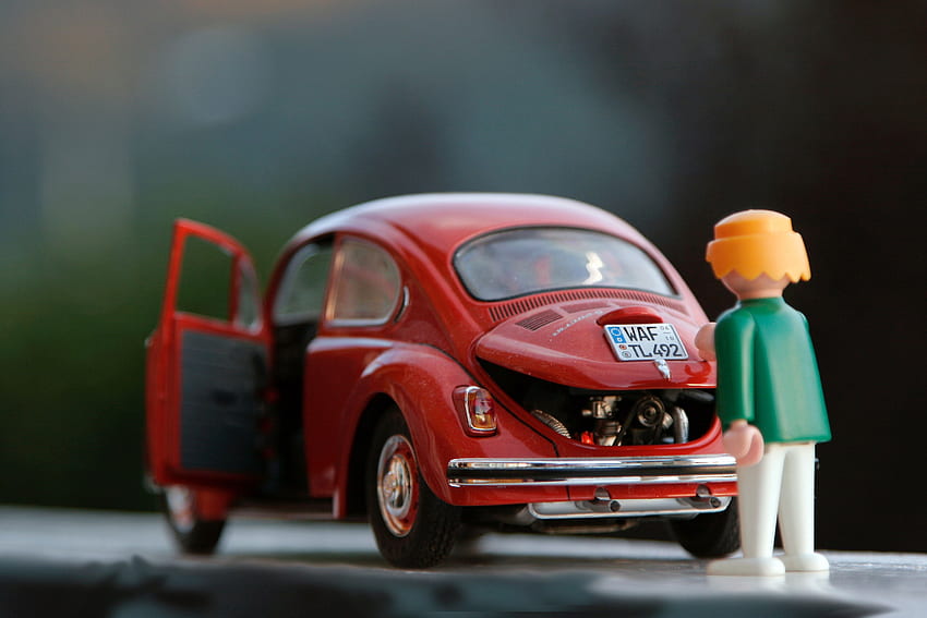 orange hair Lego toy looking at red beetle car – Toy on Unsplash HD wallpaper