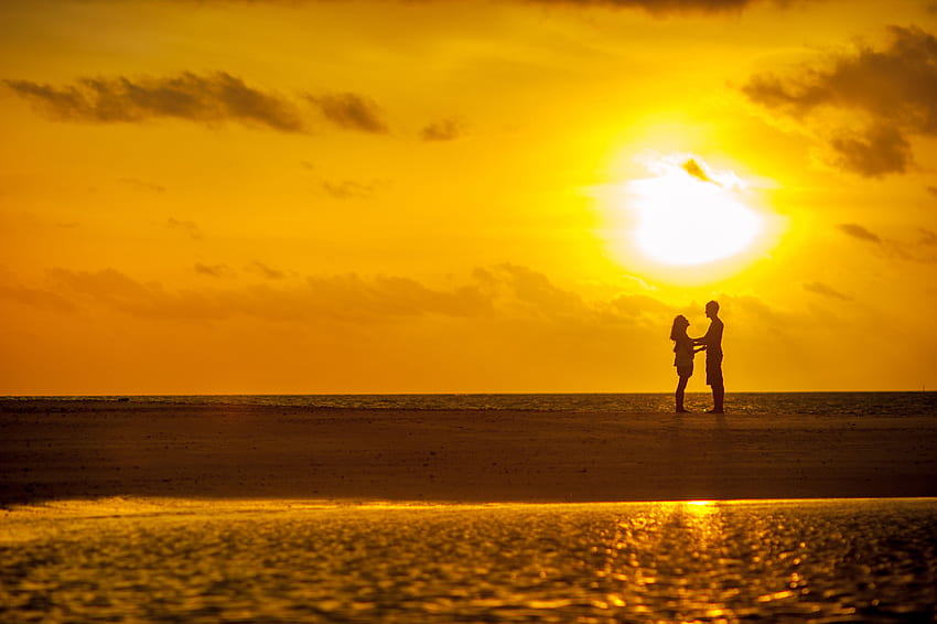 Man and Woman Standing Near Seashore Under Sunset HD wallpaper