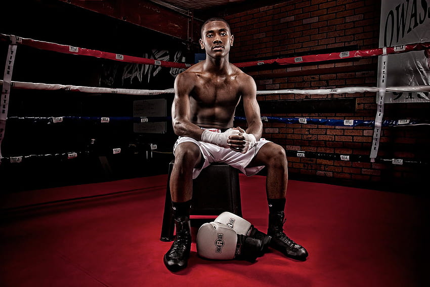 of a male boxer sitting on chair inside the boxing ring HD wallpaper