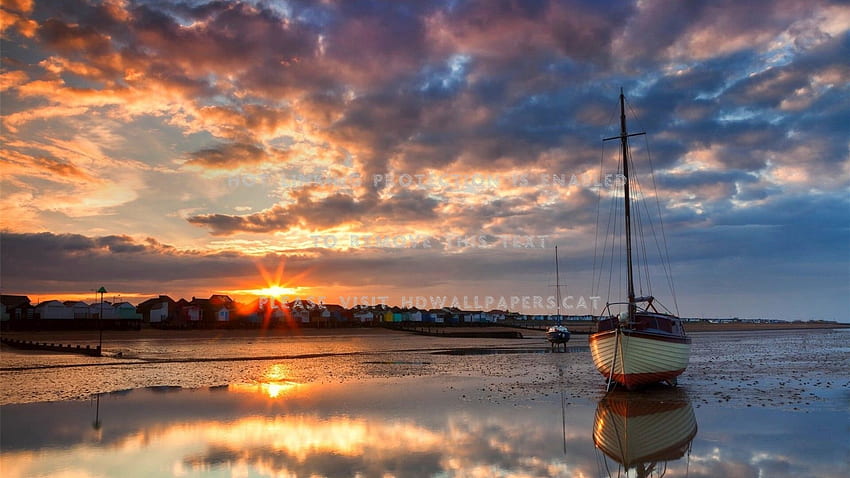 sunset over a sleepy seaside town boat HD wallpaper