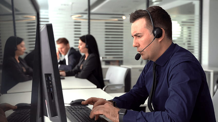 smiling man taking call in busy call center. In the background there are his colleagues also talking to clients on phone Stock Video Footage - Storyblocks HD wallpaper
